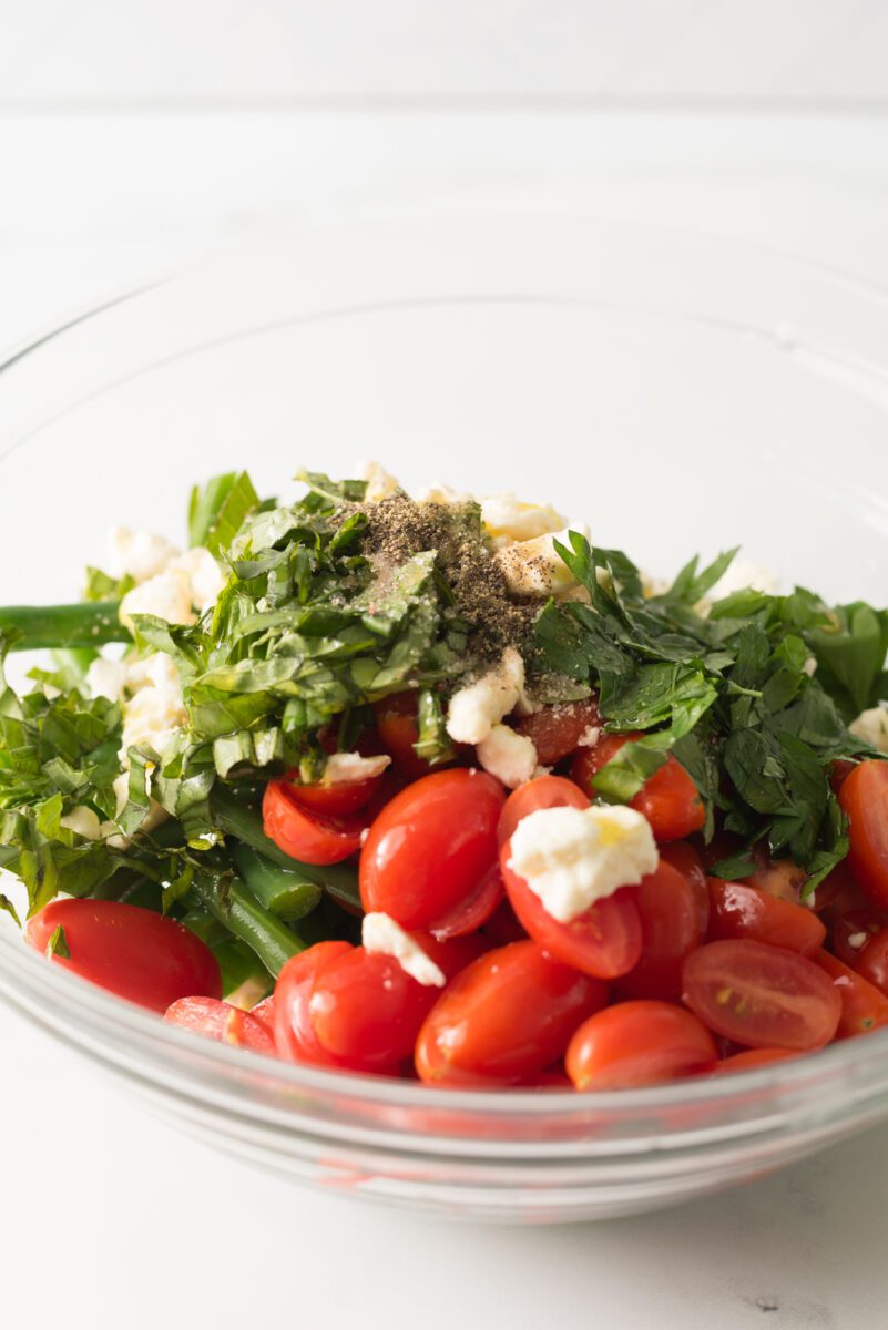 Fresh green beans with tomato and feta cheese combined with herbs and spices