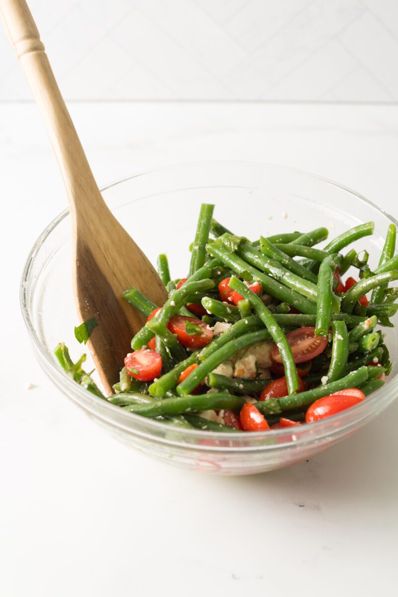 Fresh green beans with tomato and feta cheese combined with herbs and spices