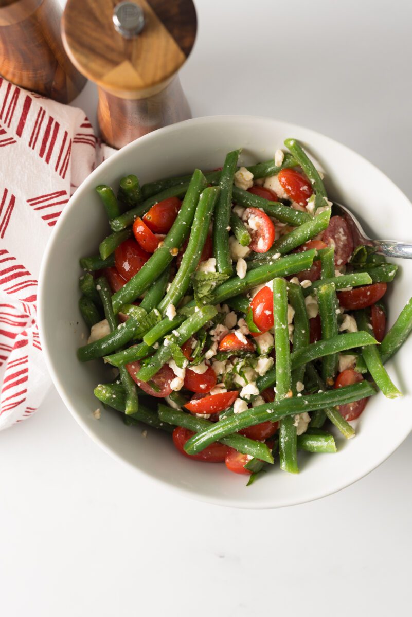 Fresh green beans with tomato and feta cheese combined with herbs and spices