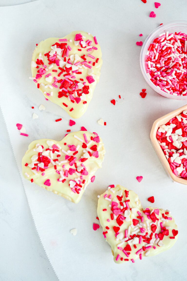 Rice Krispie treats dipped in white chocolate with Valentine Sprinkles on top