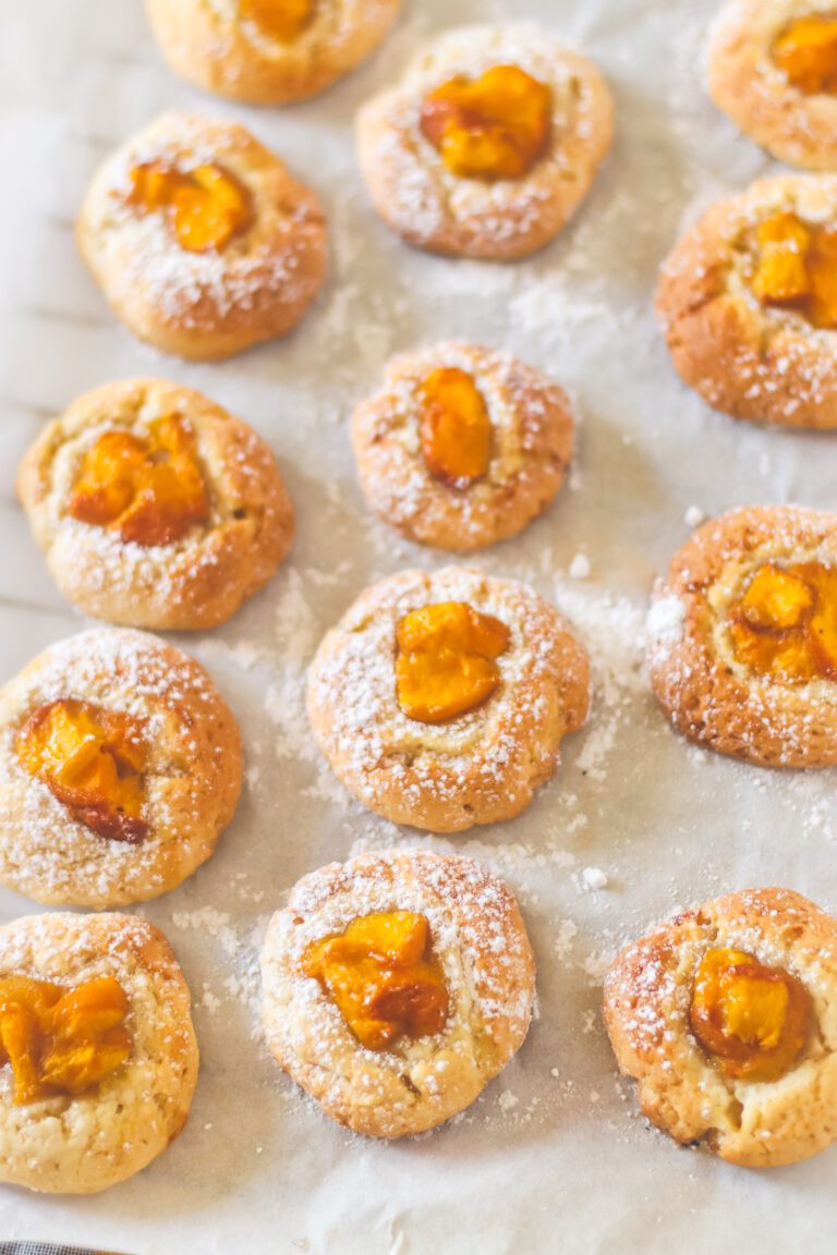 Yummy Homemade cookies with peaches in a well in the center of the dough