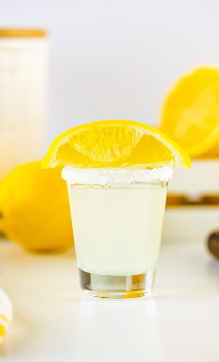 a shot glass with a sugar rim that has the classic Lemon Drop Shot inside