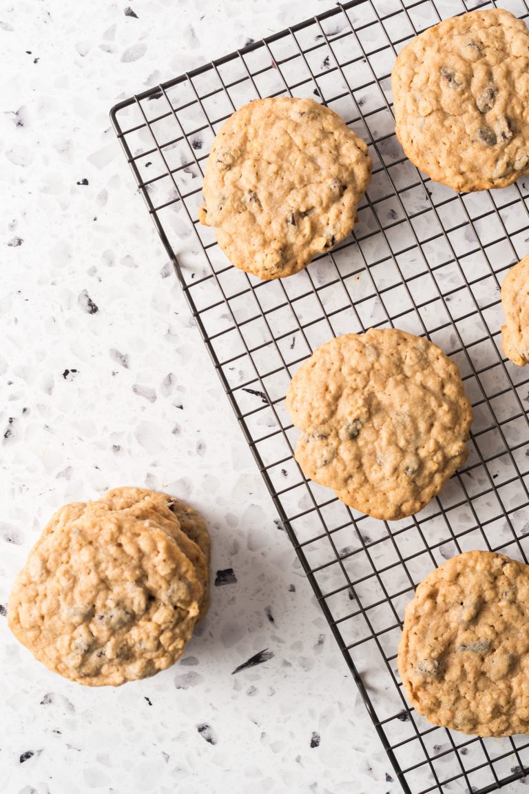 Oatmeal cookies made with bisquick pancake mix and raisins. Stacked together on a cooling rack.