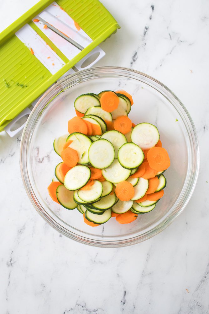 slice the sweet potato, zucchini and carrots using a mandoline or sharp knife