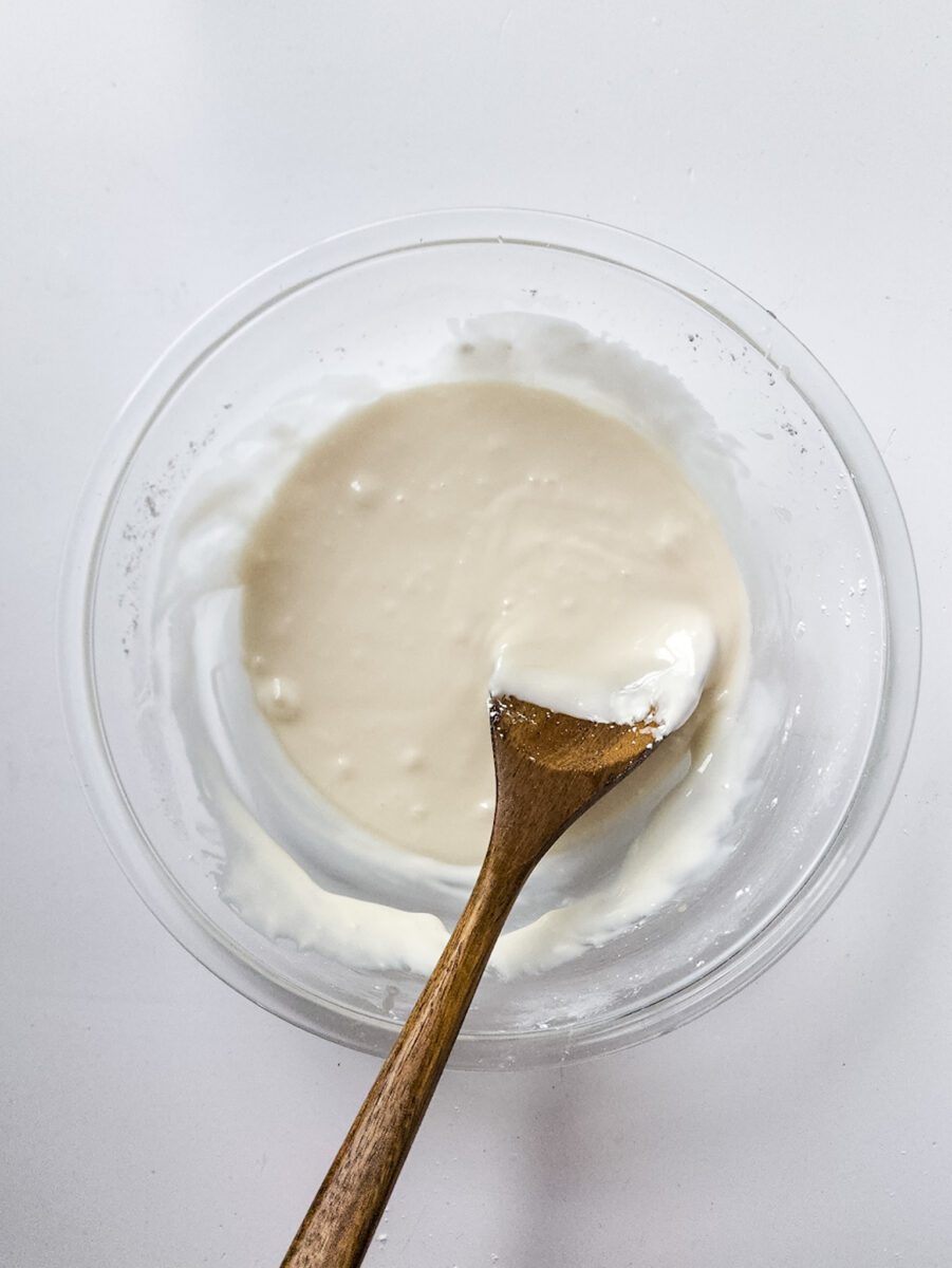 Slowly pour in the hot water while whisking the powdered sugar mixture