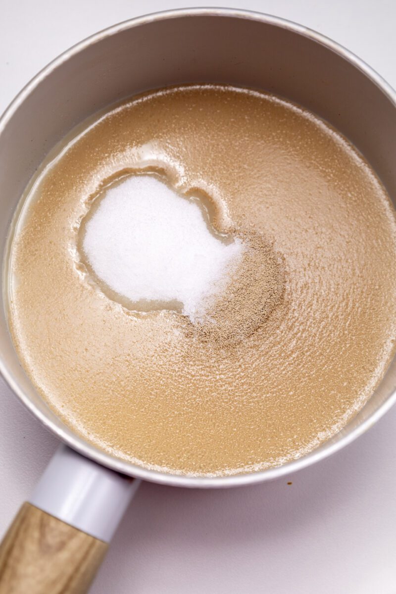 Warm up milk and mix it with dry yeast and granulated sugar