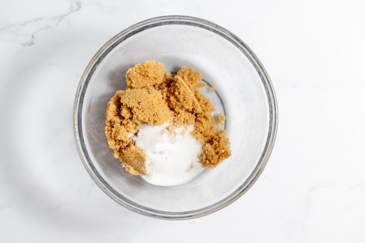 Add both sugars to a large mixing bowl, and whisk in butter