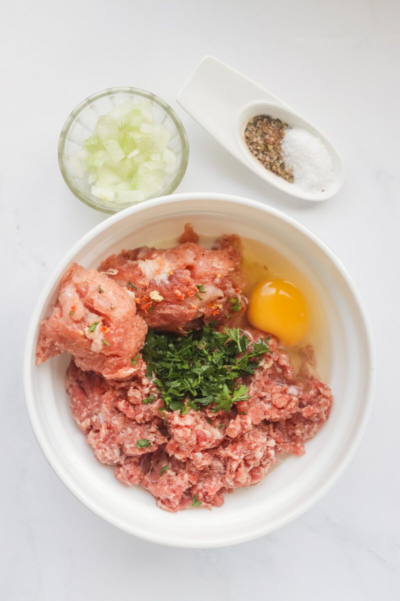All all the ingredients to make meatloaf and mix it