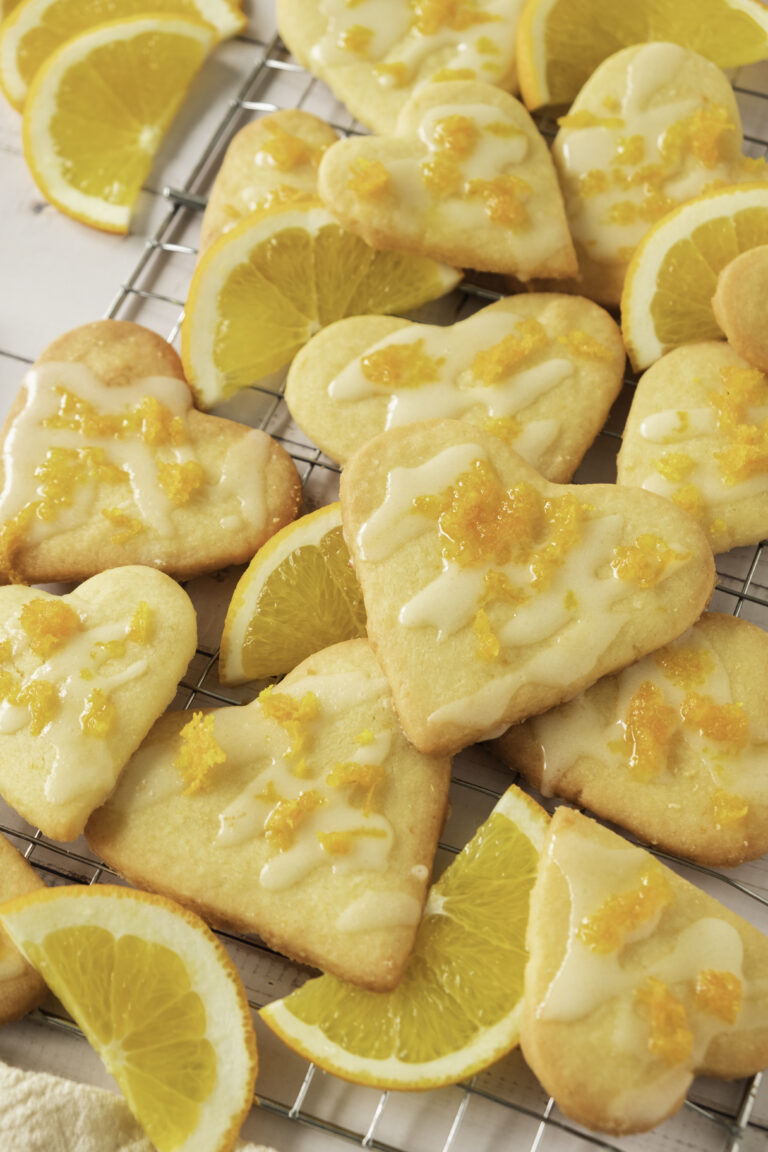 Easy Orange shortbread cookie recipe cut into heart shapes with an orange zest glaze.