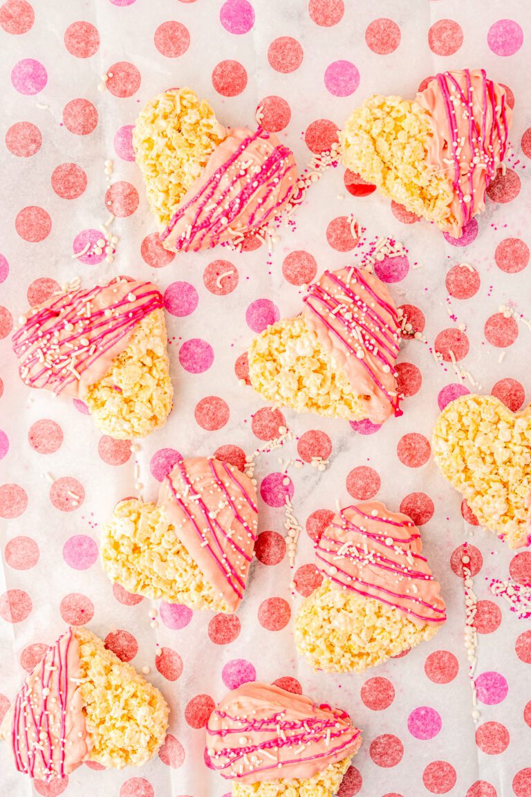 Rice Krispie treats shaped as hearts. Dipped in pink chocolate with hot pink piping and sprinkles.